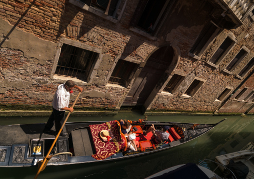 Gondola on a canal with tourists, Veneto Region, Venice, Italy
