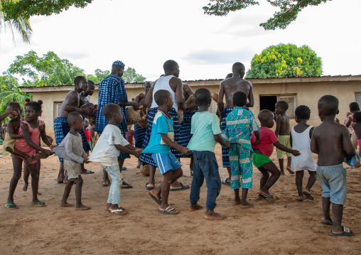 Musicians performing and children dancing during a Goli sacred mask dance in Baule tribe, Région des Lacs, Bomizanbo, Ivory Coast
