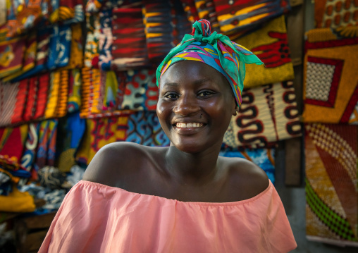 Portrait of a smiling african woman inside a shop, Sud-Comoé, Grand-Bassam, Ivory Coast