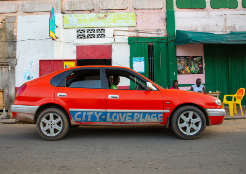 Red taxi with the slogan city love plage on the car, Sud-Comoé, Grand-Bassam, Ivory Coast