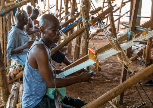 African men weaving in a traditional textile factory, Savanes district, Waraniene, Ivory Coast