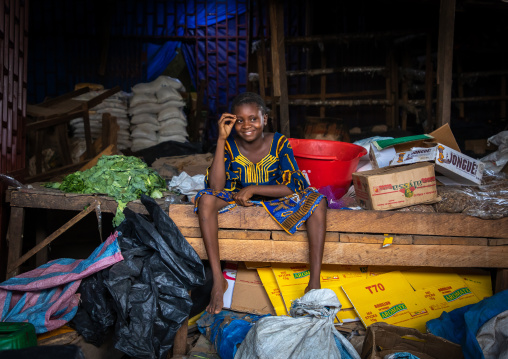 African girl sit in a market stall, Poro region, Korhogo, Ivory Coast