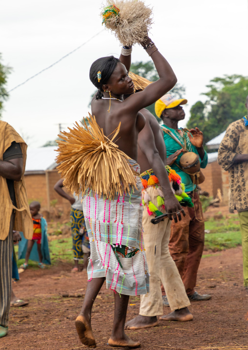 Young Senufo shirtless woman dancing the Ngoro during a ceremony, Savanes district, Ndara, Ivory Coast