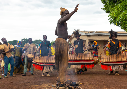 Shirtless man walking in the fire during the Ngoro dance, Savanes district, Ndara, Ivory Coast