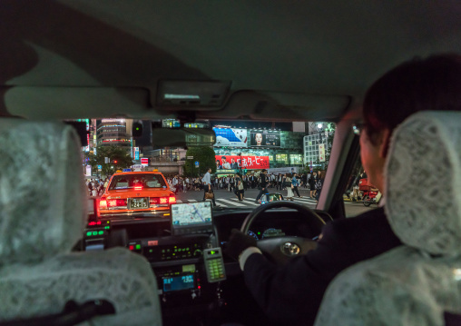 A taxi driver inside his car at night in shibuya, Kanto region, Tokyo, Japan