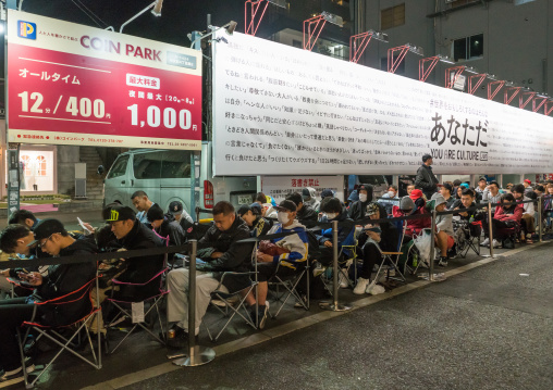 People queueing and sleeping in the street for the opening of a new shop, Kanto region, Tokyo, Japan
