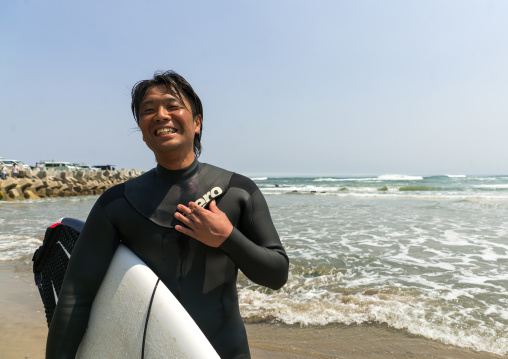 Japanese surfer in the contaminated area after the daiichi nuclear power plant irradiation, Fukushima prefecture, Tairatoyoma beach, Japan