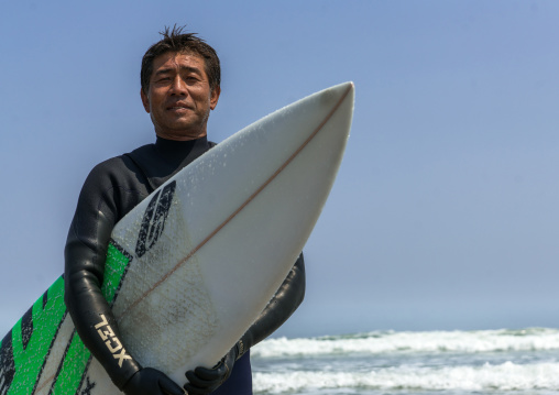 Japanese surfer in the contaminated area after the daiichi nuclear power plant irradiation, Fukushima prefecture, Tairatoyoma beach, Japan