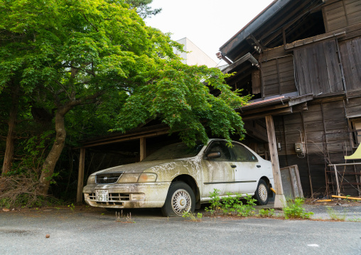 Abandoned car after the 2011 earthquake and tsunami five years after in the difficult-to-return zone, Fukushima prefecture, Tomioka, Japan