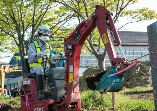 Decontamination work no entry sign in front of workers who remove top soil contaminated by nuclear radiations after the daiichi nuclear power plant explosion, Fukushima prefecture, Iitate, Ja