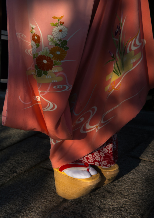 A maiko called chikasaya walking with her traditional maiko clogs, Kansai region, Kyoto, Japan