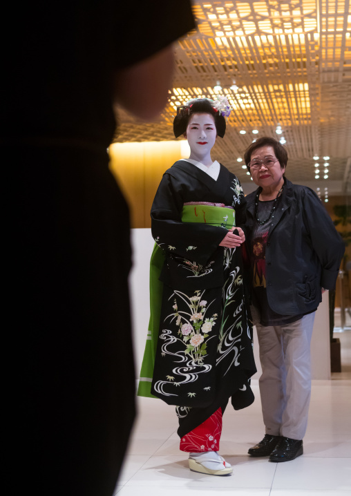 Maiko in hayatt hotel hall posing for tourists, Kansai region, Kyoto, Japan