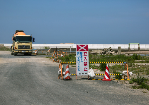 No entry sign in front of a truck in the highly contaminated area after the tsunami and the daiichi nuclear power plant irradiation, Fukushima prefecture, Namie, Japan