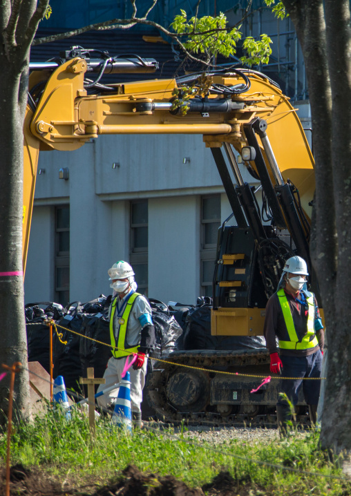 Workers remove top soil contaminated by nuclear radiations after the daiichi nuclear power plant explosion, Fukushima prefecture, Iitate, Japan