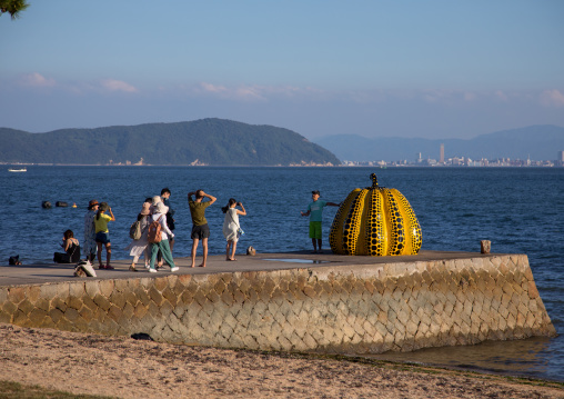 Yellow pumpkin by Yayoi Kusama on pier at sea, Seto Inland Sea, Naoshima, Japan