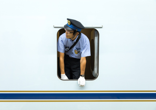 Shinkansen train controller looking thru a window, Hypgo Prefecture, Himeji, Japan
