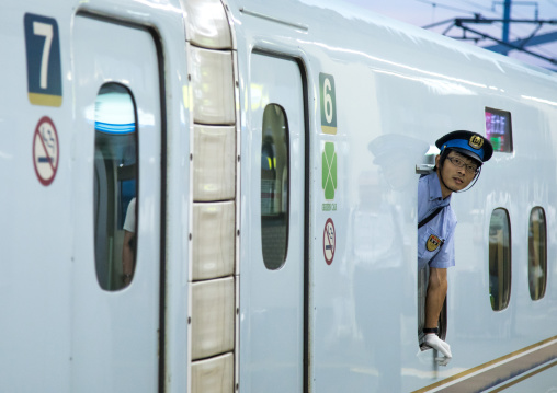 Security guard on Shinkansen bullet train platform, Hypgo Prefecture, Himeji, Japan