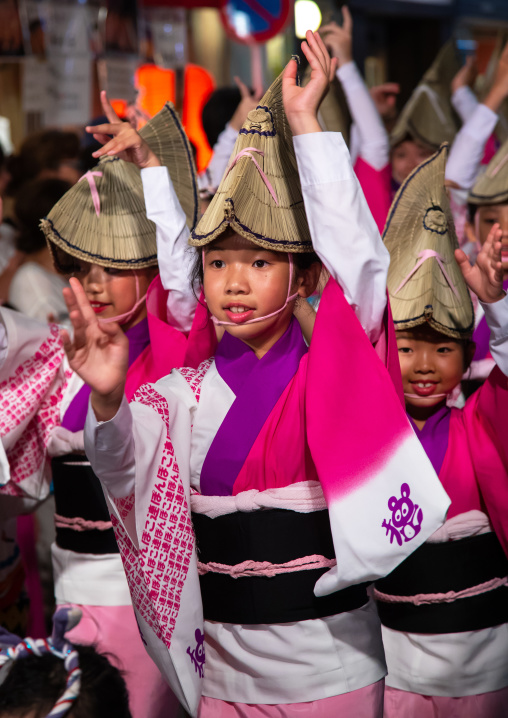Japanese children with straw hats during the Koenji Awaodori dance summer street festival, Kanto region, Tokyo, Japan