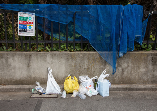 Rubbish on street in plastic bags, Kanto region, Tokyo, Japan