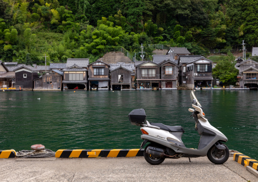 Scotter parked in front of funaya fishermen houses, Kyoto prefecture, Ine, Japan