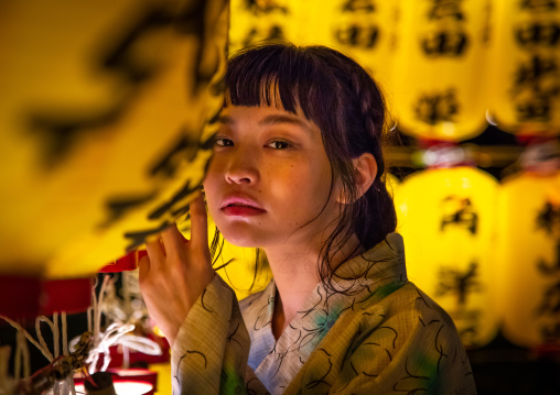 Japanese woman in yaukuta during Gokoku shrine Mitama matsuri Obon festival celebrating the return of the spirits of the deads, Kyushu region, Fukuoka, Japan