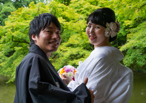 Japanese couple in traditional clothing in the botanic garden, Kansai region, Kyoto, Japan