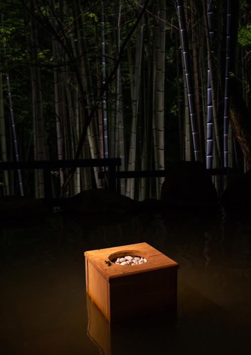 Bucket next to a bamboo forest hot spring in Takefue ryokan, Kumamoto Prefecture, Minamioguni-machi, Japan