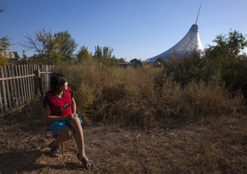 Woman Looking At Khan Shatyr Giant Tent From Her Garden In The Suburbs Of Astana, Kazakhstan