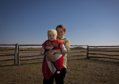 Ethnic Russian Woman Working As Tenant Holding Her Baby,  Kazakhstan