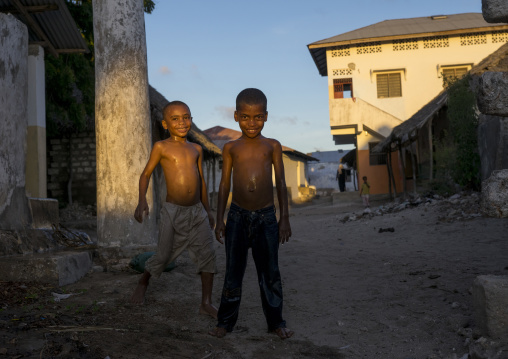 Children having a shower in the street, Lamu county, Matondoni, Kenya