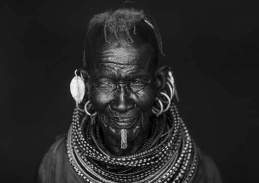 Old turkana tribe woman with huge necklaces and earrings, Turkana lake, Loiyangalani, Kenya