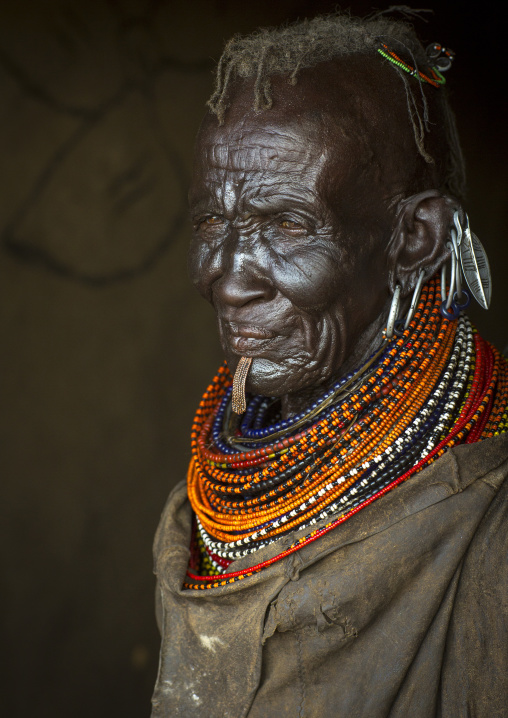 Old turkana tribe woman with huge necklaces and earrings, Turkana lake, Loiyangalani, Kenya