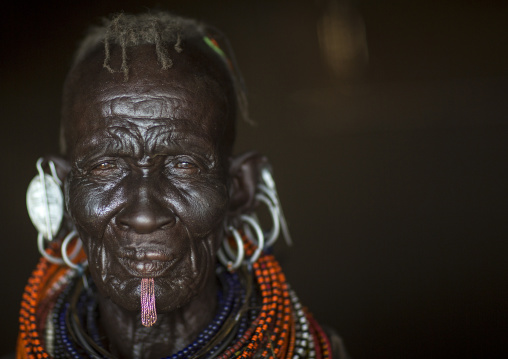 Old turkana tribe woman with huge necklaces and earrings, Turkana lake, Loiyangalani, Kenya