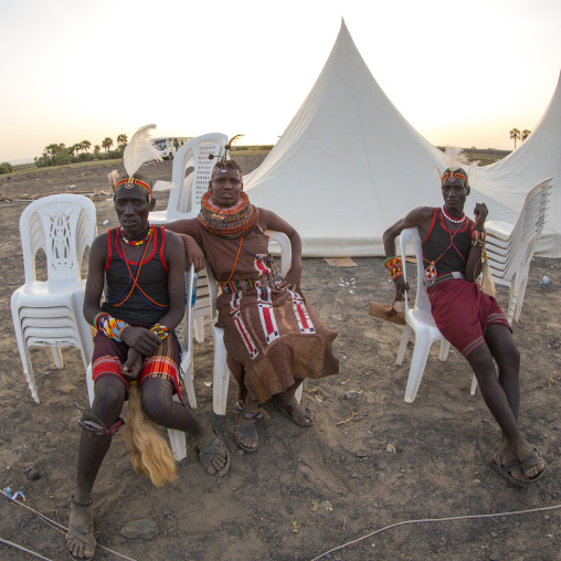 Turkana tribe people resting on plastic chairs, Turkana lake, Loiyangalani, Kenya