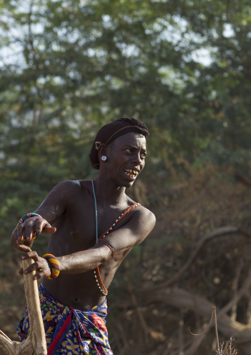 Rendille tribe man taking water in a singing well for his camels, Marsabit district, Ngurunit, Kenya