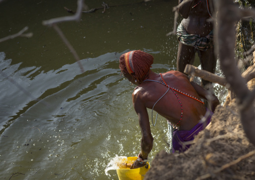 Rendille tribe men taking water in a singing well for their camels, Marsabit district, Ngurunit, Kenya
