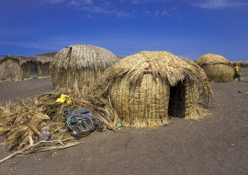 Wheelchair in front of a grass hut in el molo tribe village, Turkana lake, Loiyangalani, Kenya