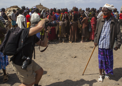 Toutist taking picture of a borana man with a red beard, Loiyangalani, Loiyangalani, Kenya