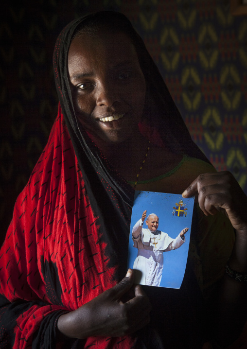 Gabbra tribe woman holding a picture of pope jean paul two, Chalbi desert, Kalacha, Kenya