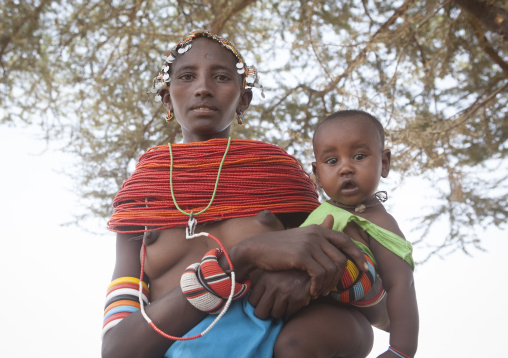 Rendille tribeswoman holding her baby, Marsabit district, Ngurunit, Kenya