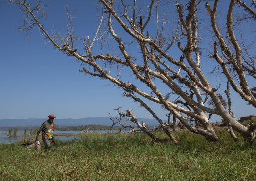 Fisherman walking on the bank, Baringo county, Baringo, Kenya