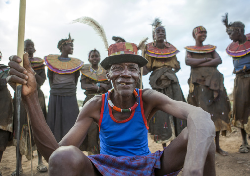 Pokot tribe people man pausing in front of the women, Baringo county, Baringo, Kenya