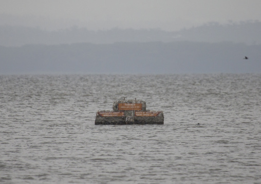 Road sign emerge from the surface of a flooded area, Nakuru district of the rift valley province, Nakuru, Kenya