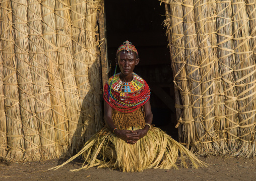 El MOlo tribe woman standing in front of her hut, Marsabit County, Loiyangalani, Kenya