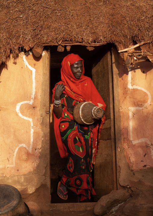 Portrait of a Borana tribe woman with a basket in front of her house, Marsabit County, Marsabit, Kenya