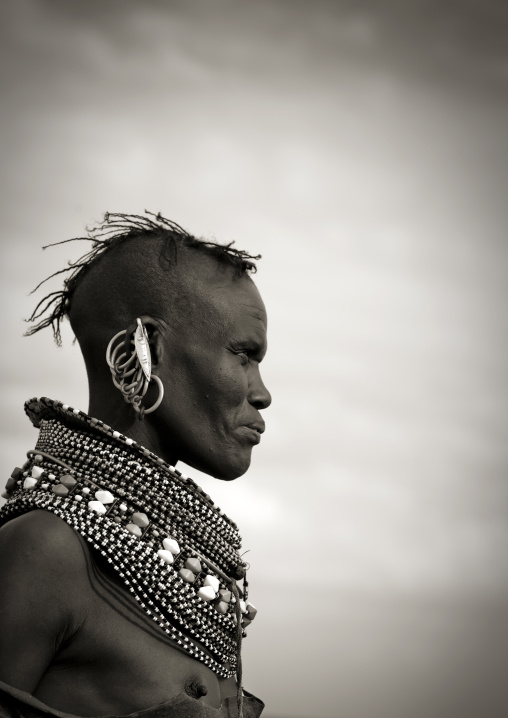 Portrait of a Turkana tribe woman with large earrings and necklaces, Rift Valley Province, Turkana lake, Kenya