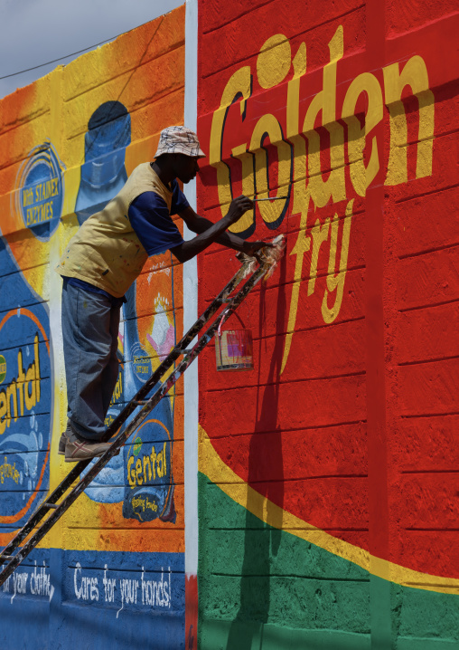 Man painting an adverstisement billboard, Rift Valley Province, Maasai Mara, Kenya