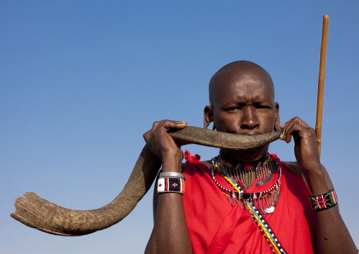 Maasai man blowing in a horn, Rift Valley Province, Maasai Mara, Kenya