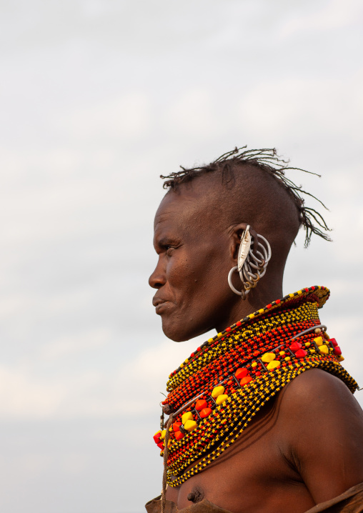Portrait of a Turkana tribe woman with large earrings and necklaces, Rift Valley Province, Turkana lake, Kenya