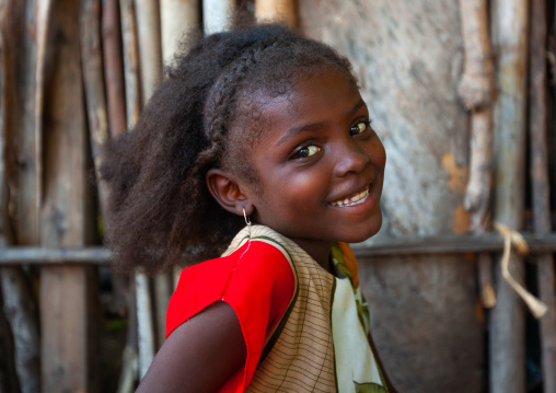 Young smiling girl with braids looking at camera, Lamu County, Lamu, Kenya